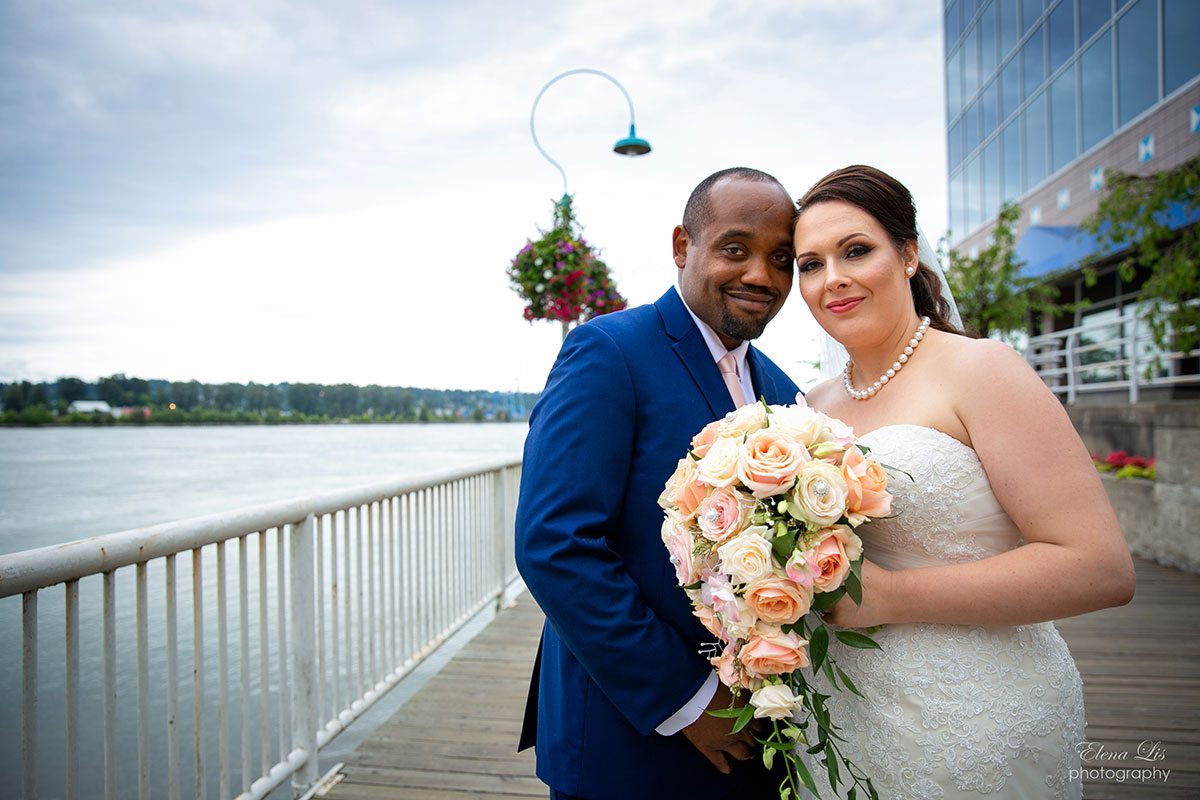 Newly weds posing for a photo at Inn at Quay boardwalk