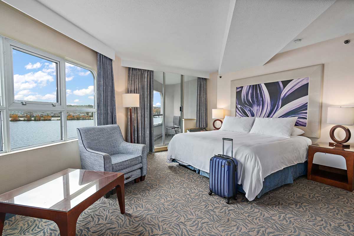Comfortable waterfront hotel room overlooking the Fraser River in New Westminster, BC, offering a relaxing fall getaway and scenic riverside views.