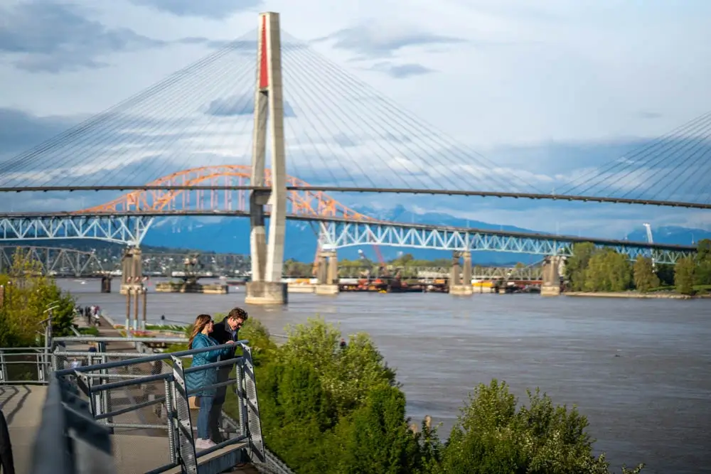 walking along boardwalk with skytrain bridge in background